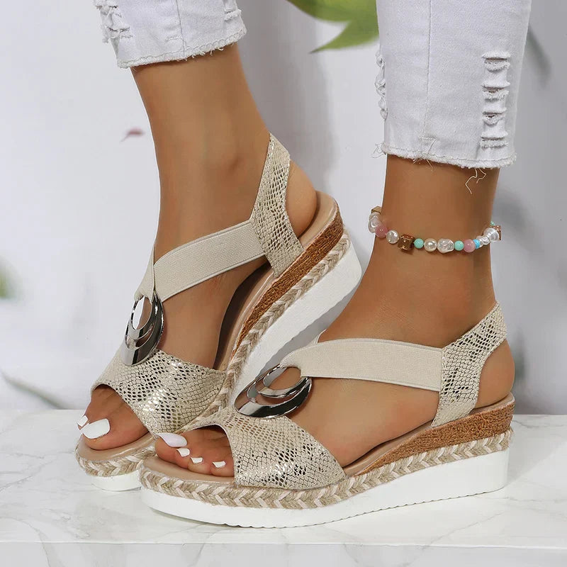Sandals with snake print and wedge heel